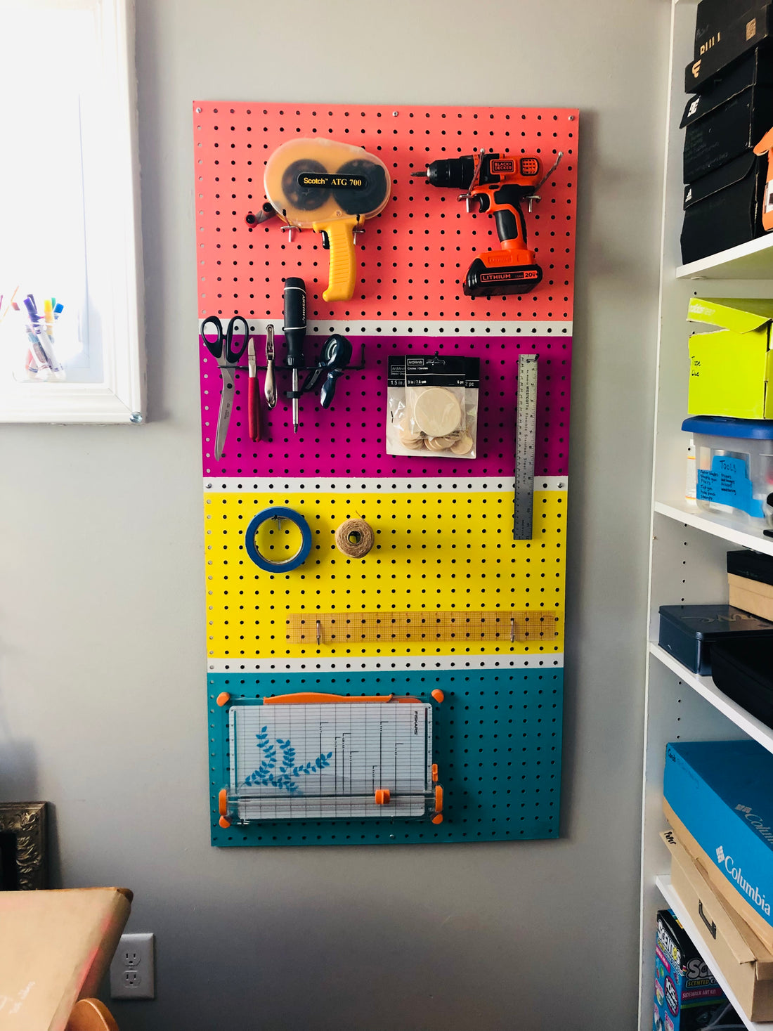 Diy coral, pink, yellow and turquoise painted peg board to organize and brighten a work space